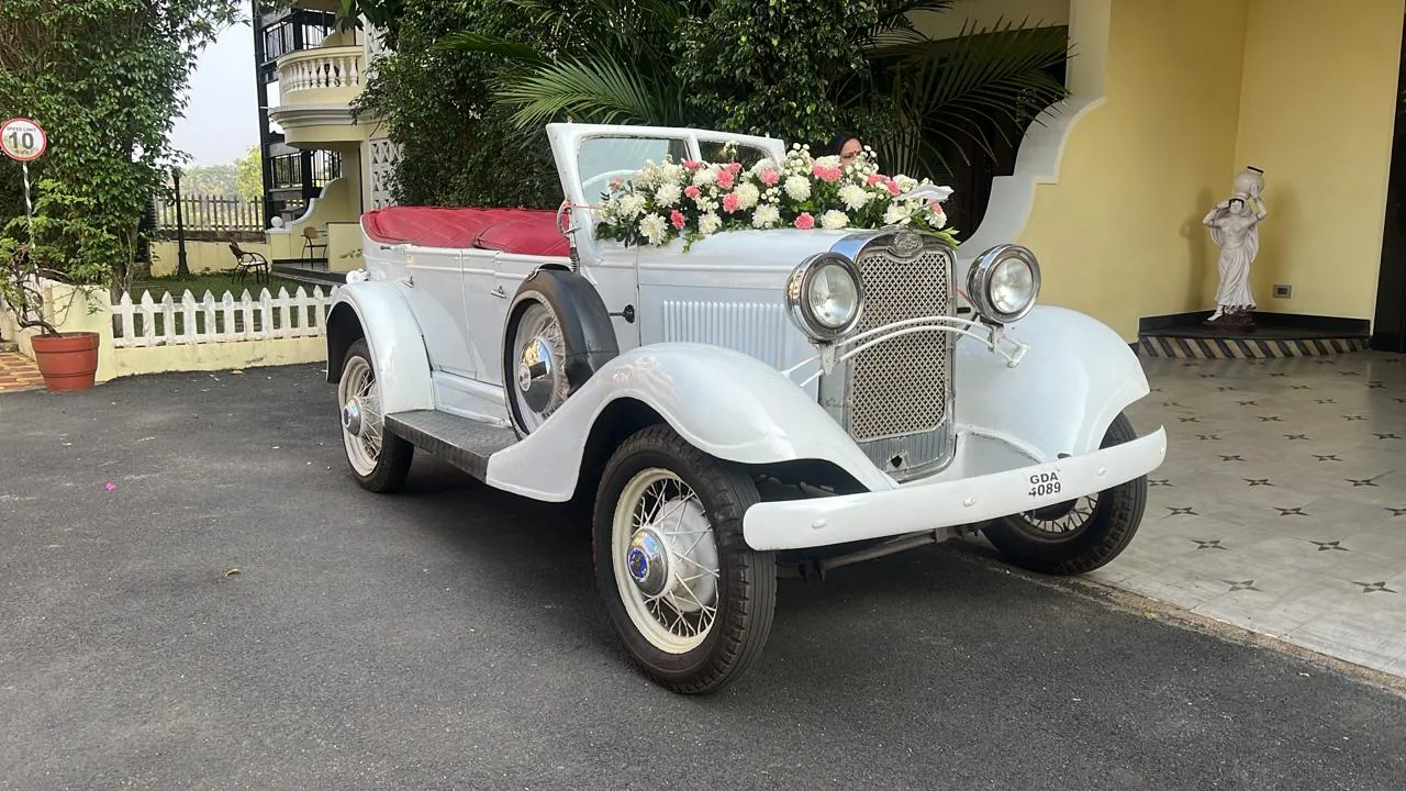 Classic white open-top wedding car available in Goa