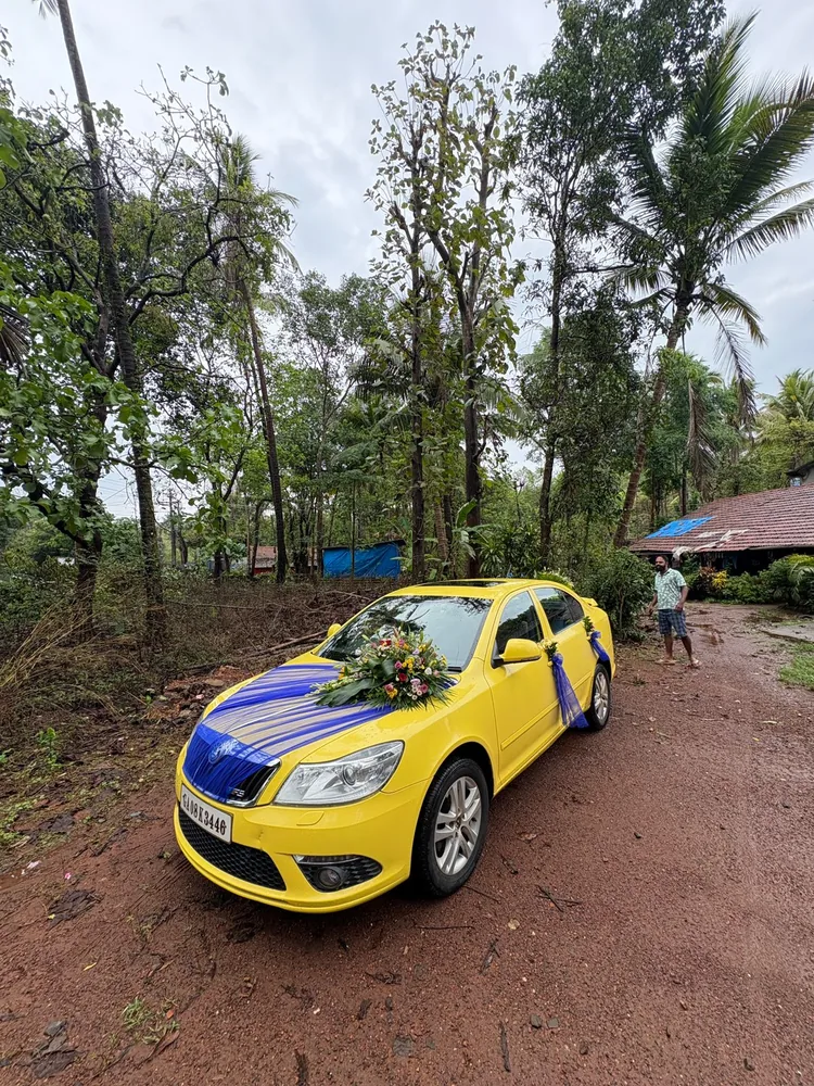 Yellow Skoda wedding car decorated with flowers in Goa